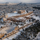 The snow covered Ancient Temple of Parthenon atop the Acropolis covered in snow.